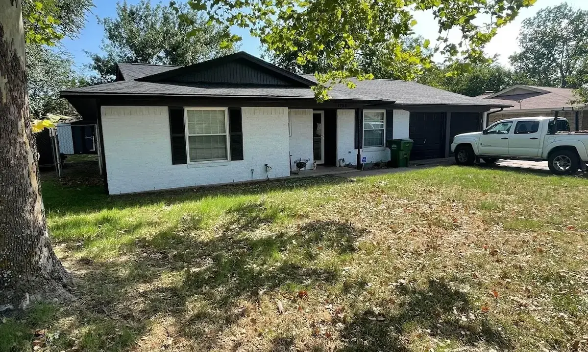 Professional roofing crew working on a residential roof in Wauseon